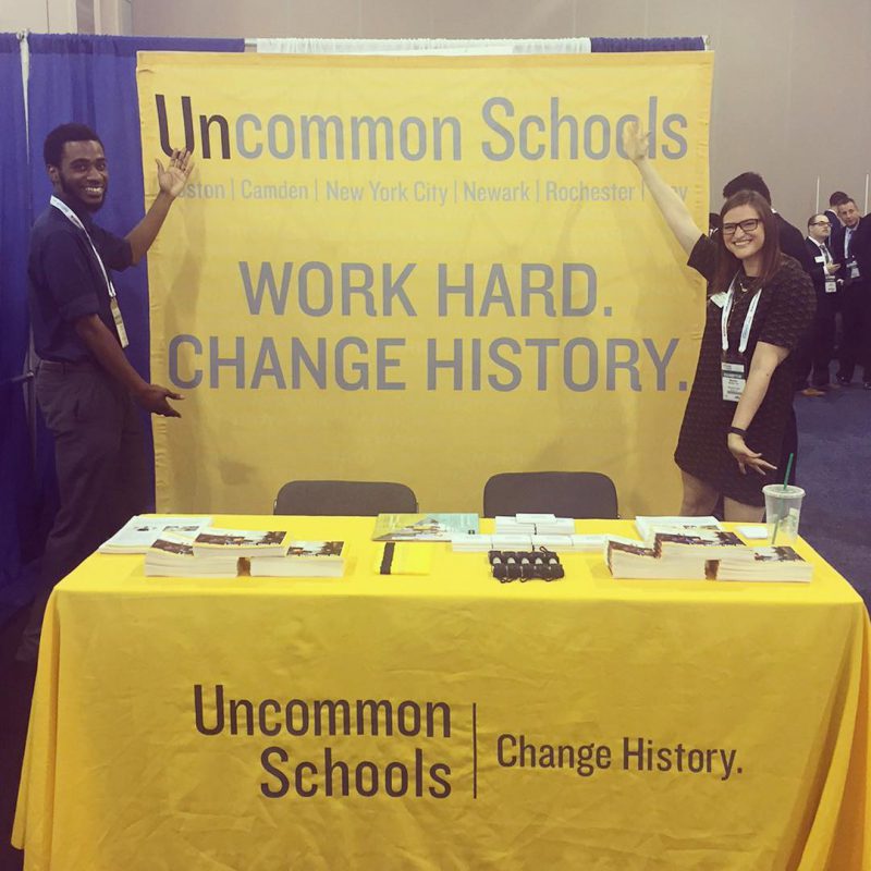 Man and woman display Uncommon Schools table