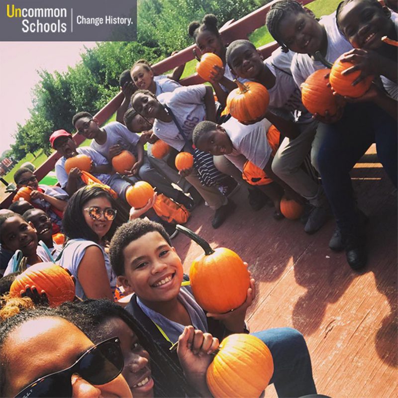 Students pose with pumpkins
