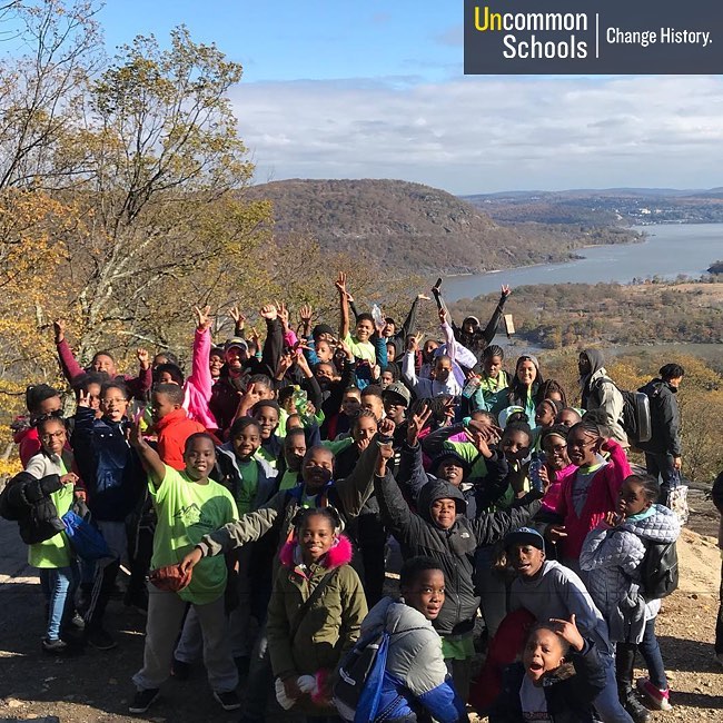 Students pose with peace signs on top of Bear Mountain
