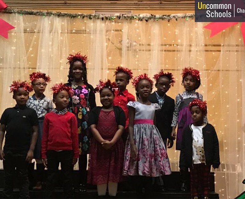 Students with festive headbands perform on stage