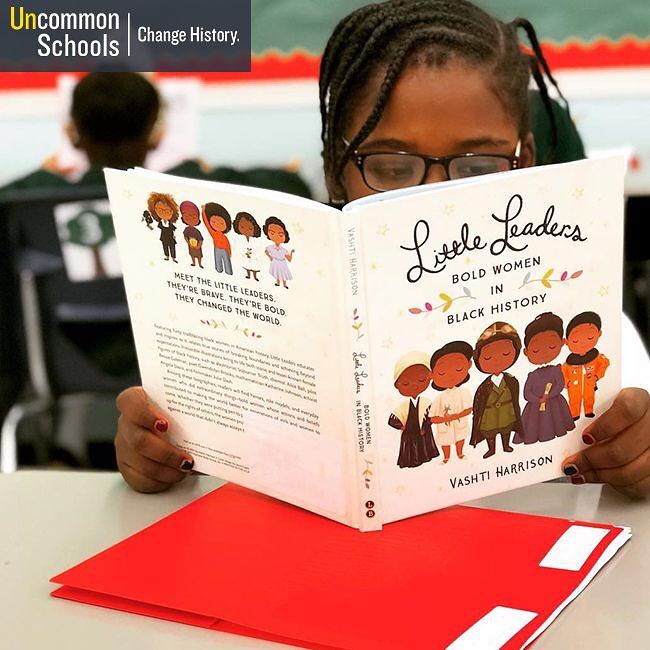 Student reads the book "Little Leaders"