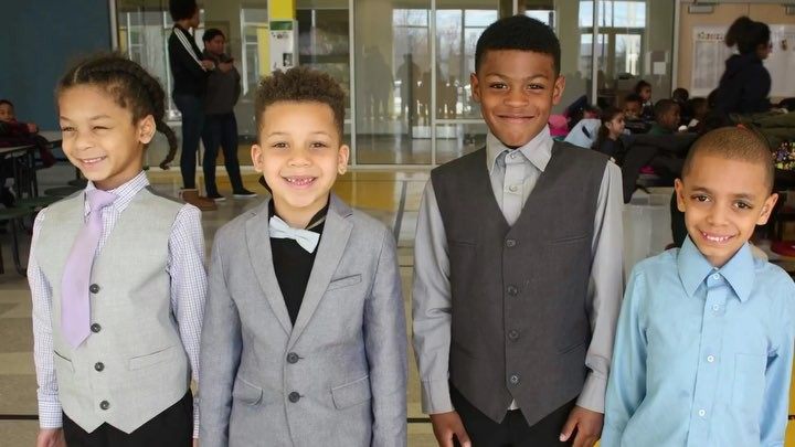 Four young boys pose in formalwear