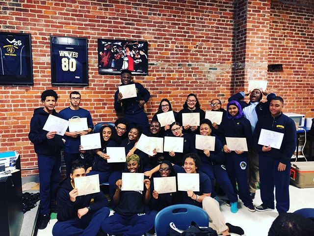 Students hold up honor roll certificates