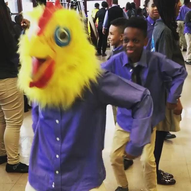 Student dances with a chicken mask on