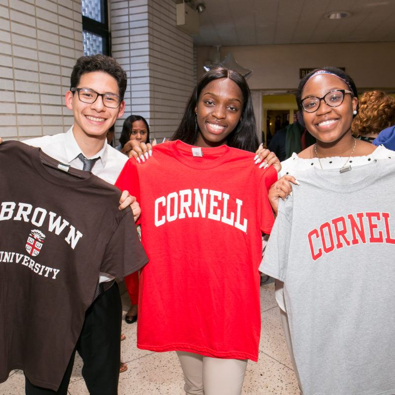 Students hold college tshirts