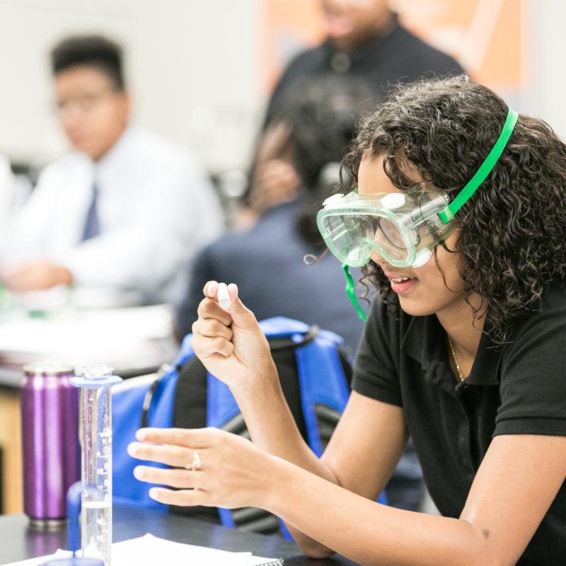 Student wearing goggles in a lab classroom