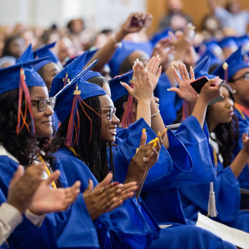 Students at graduation clapping