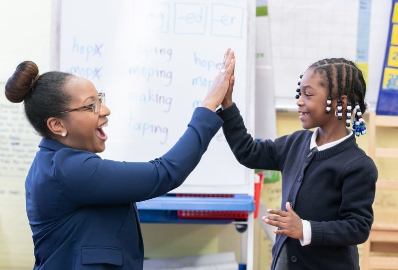 Teacher excitedly giving a student a high five