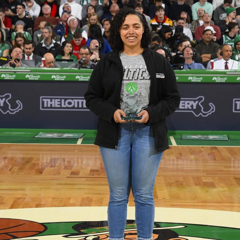 Titciana Barros receives an award during a Boston Celtics game in 2019