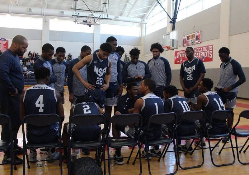 North Star Varsity Basketball Players huddle during a game