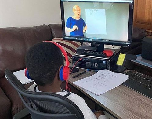 student watches a video lesson during remote learning