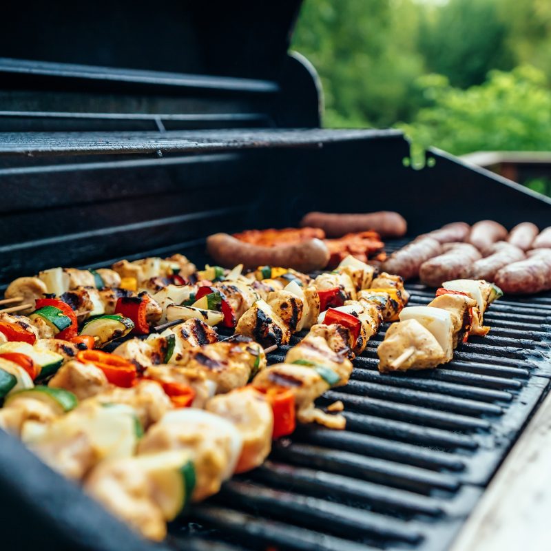 various meats and vegetables are laid out on a bbq grill