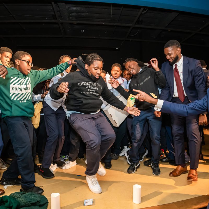 Images of students from Excellence Boys and students of Morehouse College celebrating together