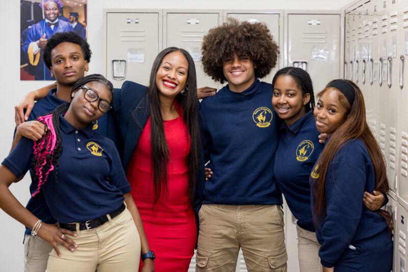 High School principal and students in front of lockers