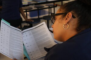 student reading a work booklet