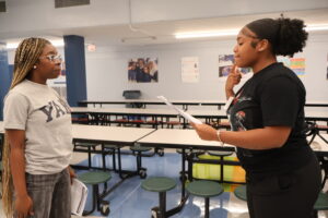 two female students practicing prompts together