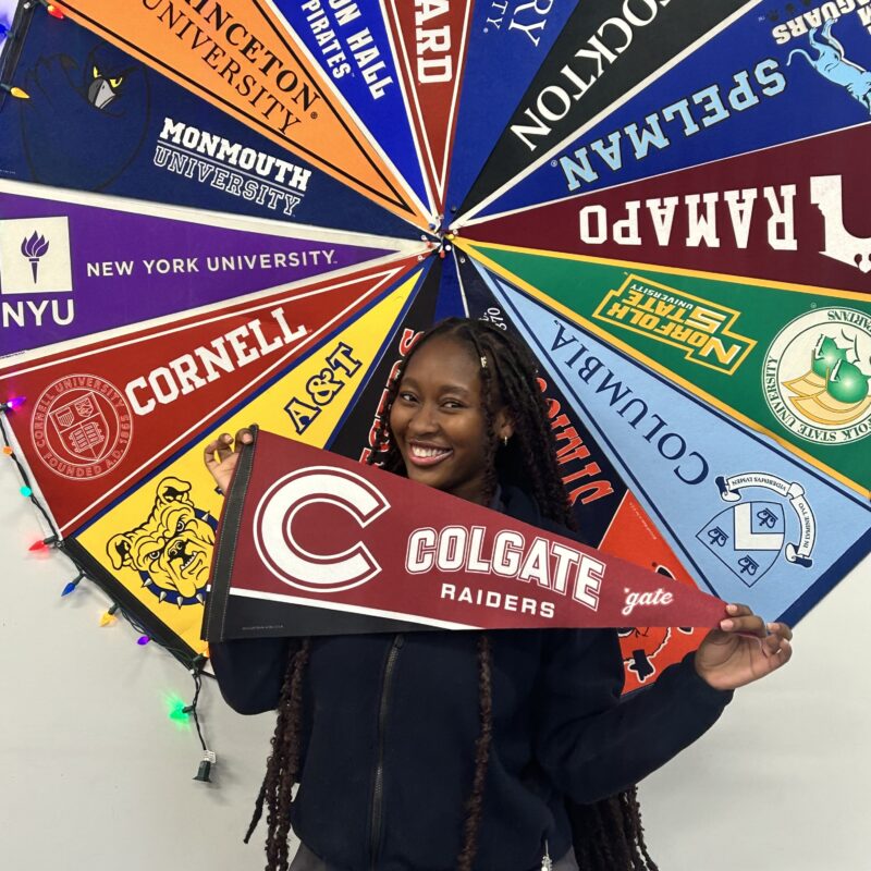 LPHS Senior posing with pennant from Colgate College where she received a full-ride scholarship