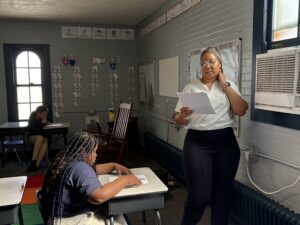 teacher in the front of the room reading to students