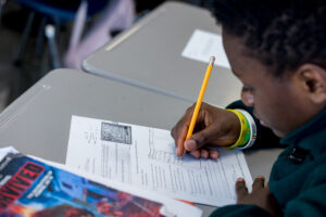 male student completing an assignment